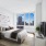 furnished bedroom brightened by large windows
