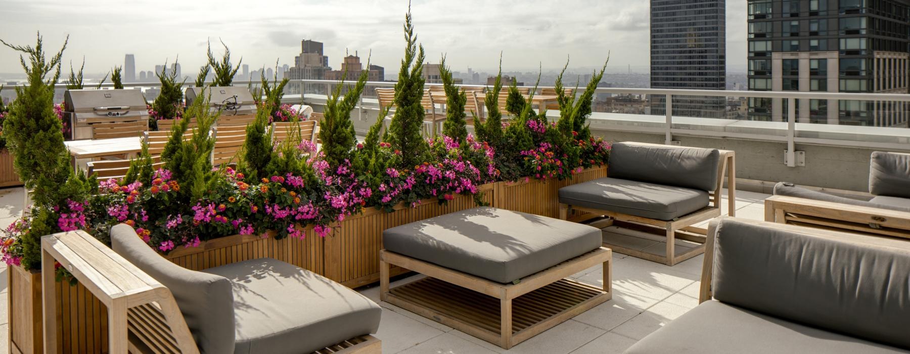 rooftop terrace with tables, chairs and planters