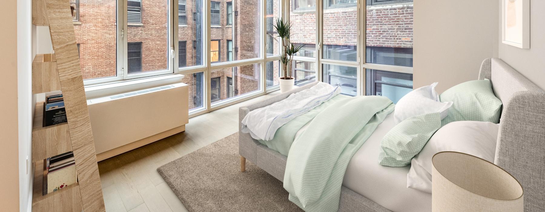 bedroom surrounded by windows with city views